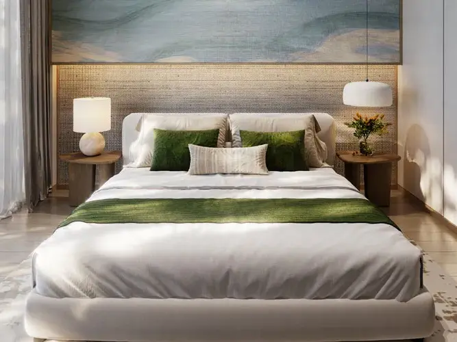 Bedroom with a white bed, green throw and woven headboard wall