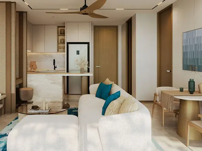 Living room with a cream sofa, teal cushions and an open kitchen